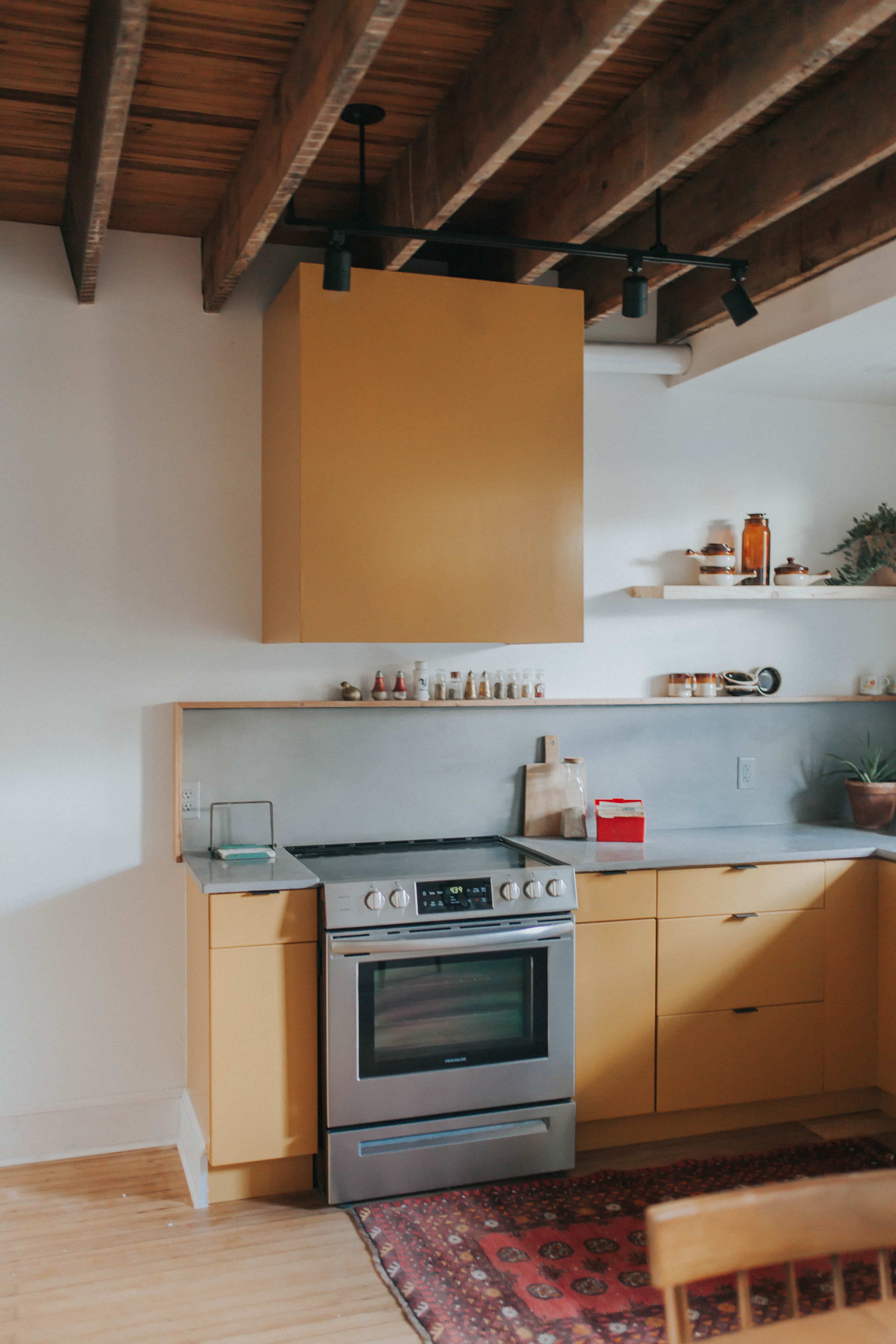 Retro kitchen with concrete countertops and Persian rug